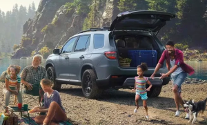 A family playing in front of a lake near their 2024 Honda Pilot. Photo taken near Ontario, California
