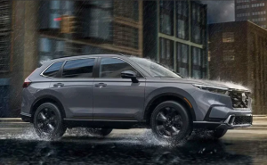 A 2024 Honda CR-V driving through city streets in the rain near Ontario, California.
