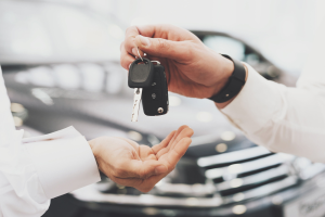 A person being handed a set of keys to their new car near Ontario, California