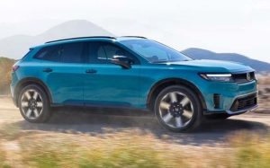 A blue 2024 Honda Prologue driving down a dirt road near Ontario, California