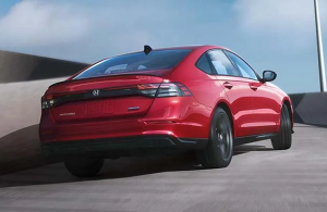 A red Honda Accord driving on a concrete pathway near Ontario, California.